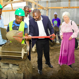 Kajiado county commissioner taking part in the production of building blocks