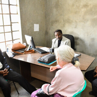 Mama Ingrid Monro the trustee founder meeting with government officials at the site office